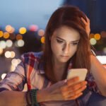 Unhappy woman texting