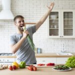 Young funny man dancing and singing