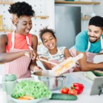 Family preparing meal and having fun in the kitchen at home
