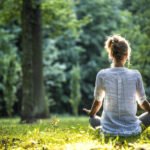 woman meditating in the park