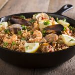 Paella -- Spanish Seafood and Rice Dish in Skillet